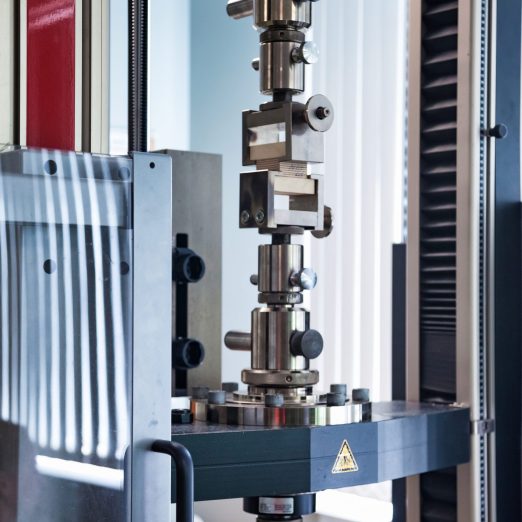 A specialized piece of equipment is set up inside a scientific laboratory to conduct material tests.